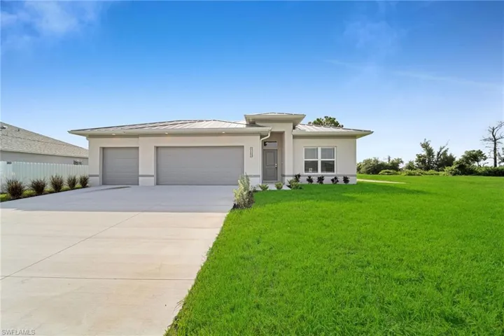 Prairie-style house featuring a front lawn and a garage