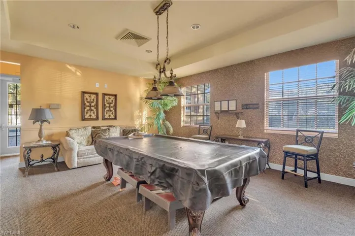 Recreation room featuring a tray ceiling, carpet, pool table, and recessed lighting