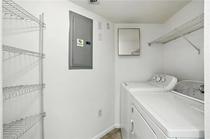 Washroom featuring electric panel and separate washer and dryer