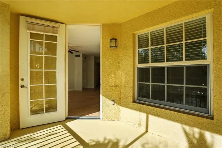 Doorway to property with stucco siding
