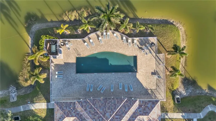 View of subject property featuring a pool