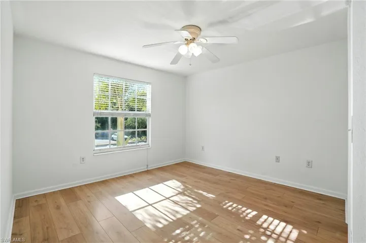 Empty room featuring light wood-type flooring and ceiling fan