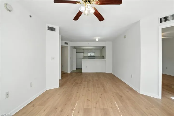 Unfurnished living room featuring a ceiling fan and light wood finished floors