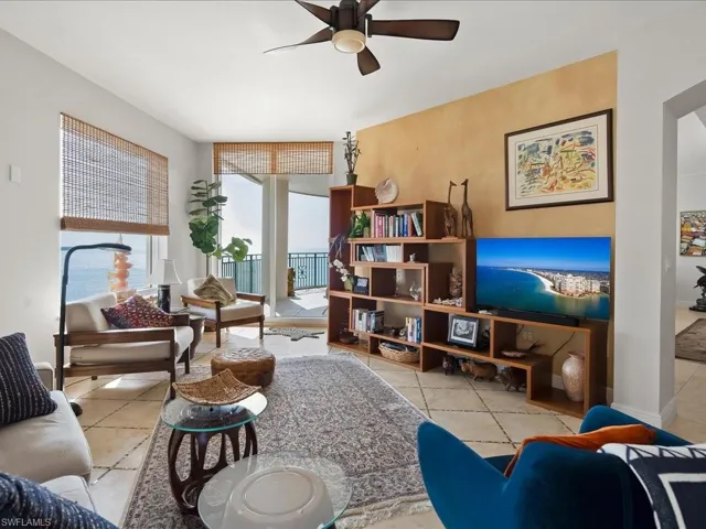 Living room featuring ceiling fan and light tile patterned floors