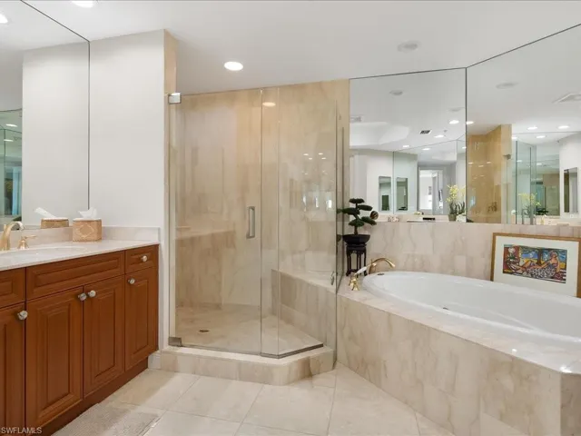 Bathroom featuring a stall shower, vanity, a garden tub, light tile patterned flooring, and recessed lighting