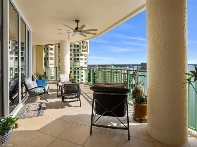 Balcony with ceiling fan, an outdoor living space, and a sunroom