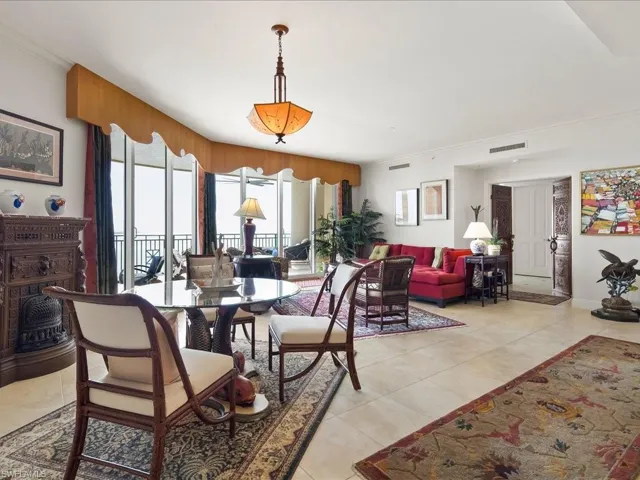 Dining area featuring ornamental molding and light tile patterned flooring