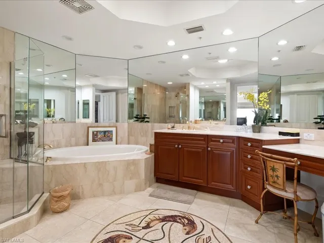 Bathroom featuring a shower stall, a bath, vanity, light tile patterned floors, and recessed lighting