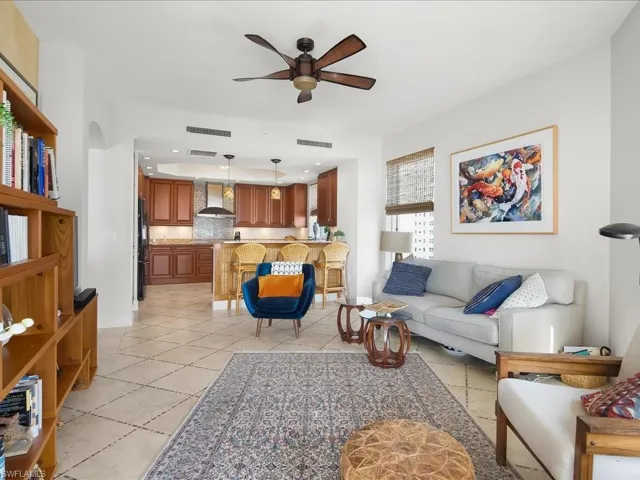 Living room with ceiling fan, recessed lighting, and light tile patterned flooring