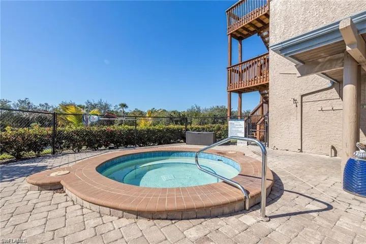 Circular spa with tiled interior, surrounded by a brick paver patio