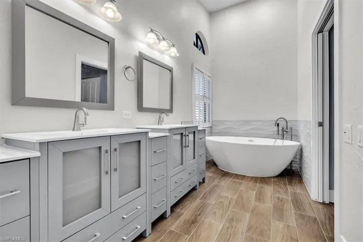 Freestanding soaking tub with floor-mounted faucet