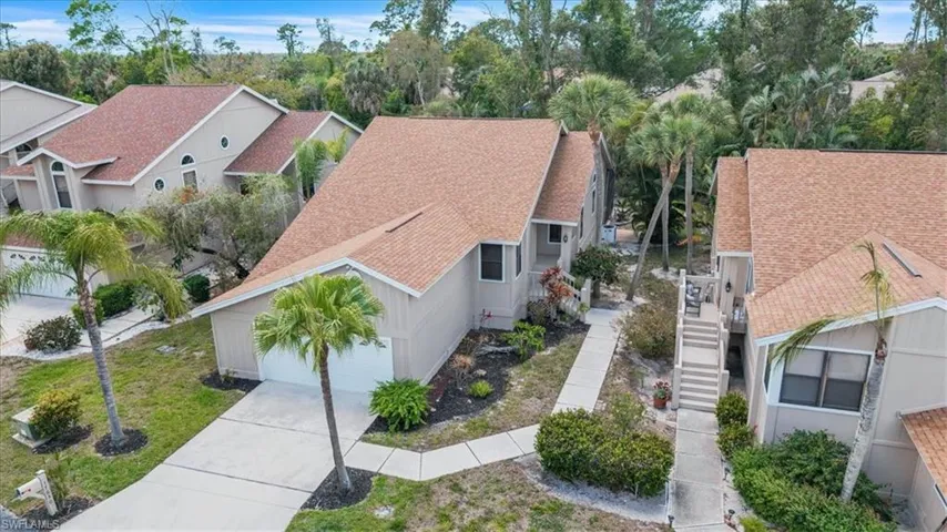 Single-story residence featuring a neutral exterior, a new shingle roof, an attached garage, and a concrete driveway