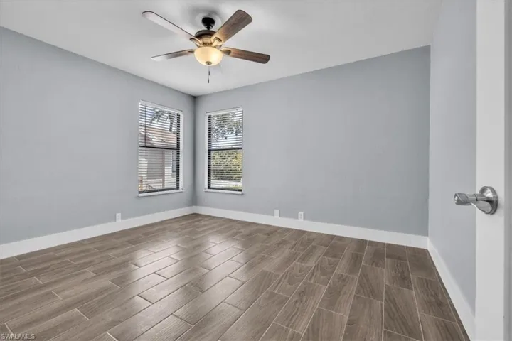 Room featuring wood-finish tile flooring and light gray walls