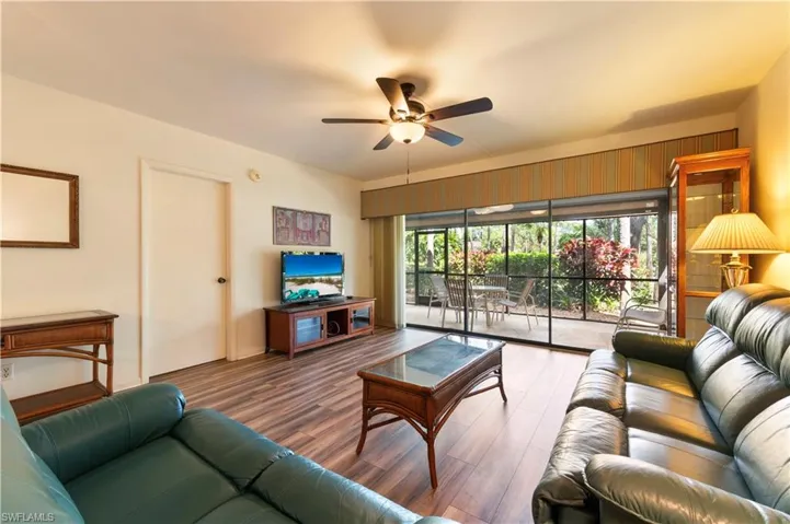 Living area with a ceiling fan and wood finished floors