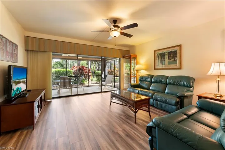 Living room with wood finished floors and ceiling fan