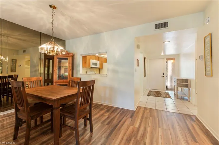 Dining room featuring light wood finished floors and a chandelier