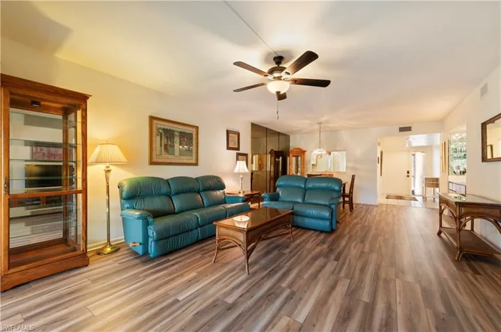 Living area with wood finished floors and a ceiling fan