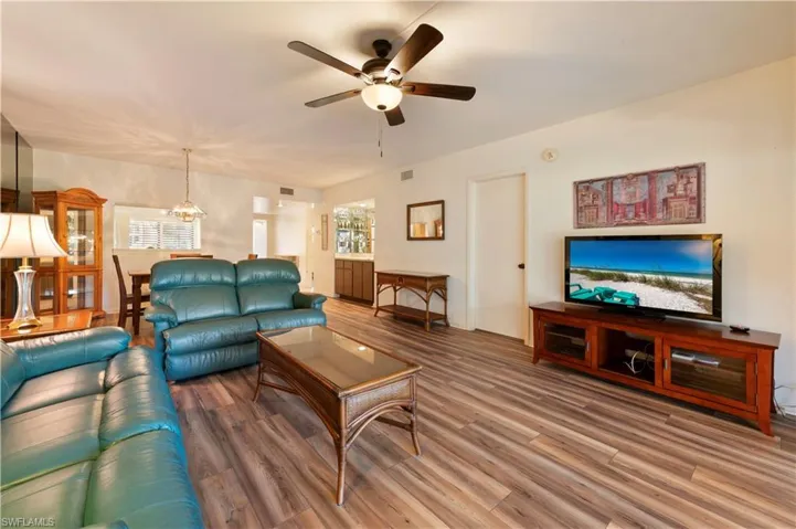 Living room with wood finished floors and a ceiling fan