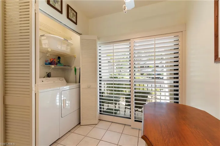 Laundry area with light tile patterned floors and separate washer and dryer