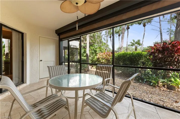 Lanai with a textured wall, stone tile flooring, and plenty of natural light
