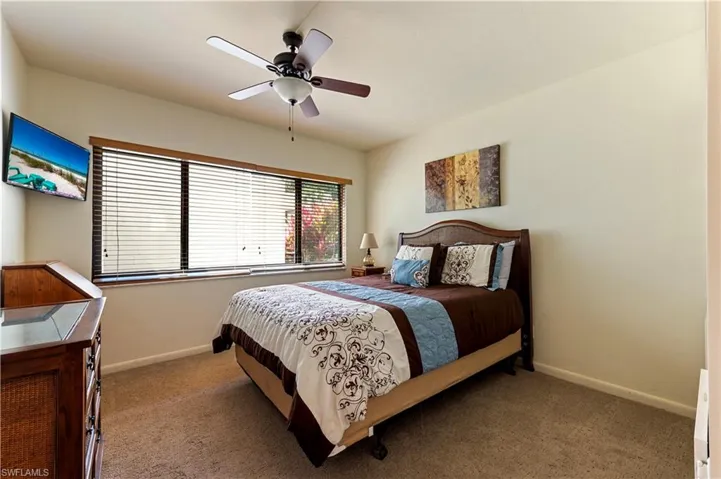 Bedroom with a ceiling fan and carpet floors