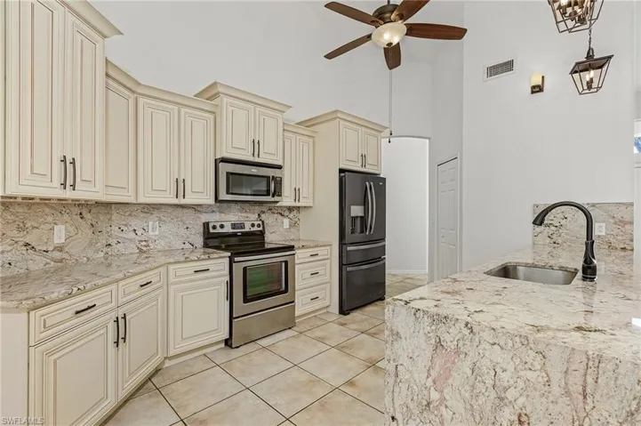 Kitchen with tasteful backsplash and stainless steel appliances