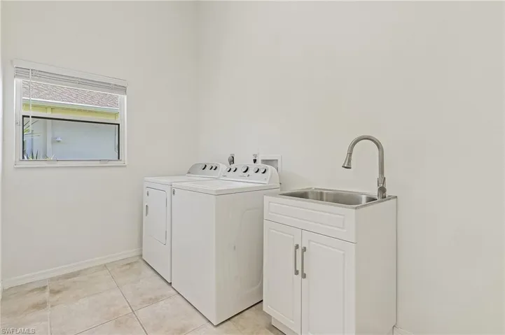 Laundry room with washer, dryer and laundry tub