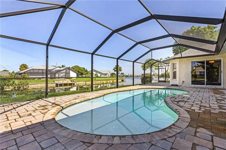 View of pool with a patio area and a lanai