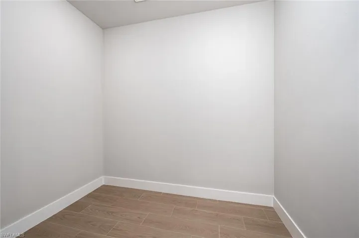 Spare room with wood finish floors and baseboards