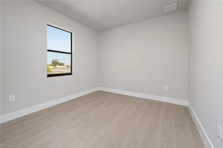 Empty room featuring wood finish floors and baseboards