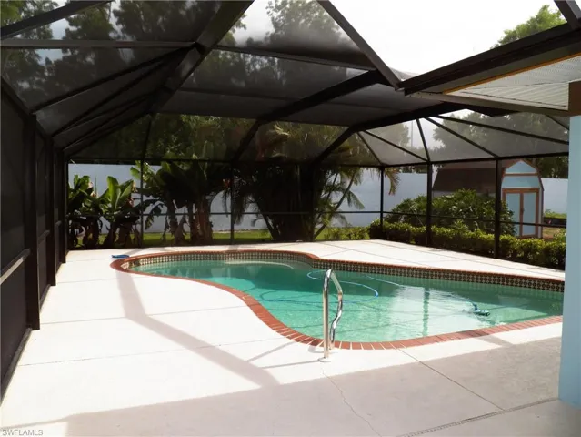 Large screened pool area and shed in backyard