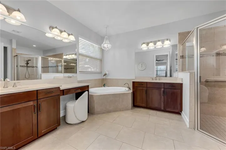 Primary bathroom features dual vanities, a LARGE walk-in shower AND soaking tub.