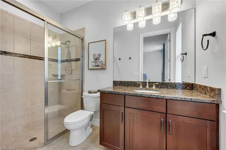 Ensuite guest bathroom features a walk-in shower.