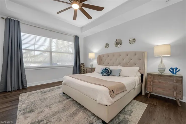 Stunning primary bedroom suite with lake and pool views!