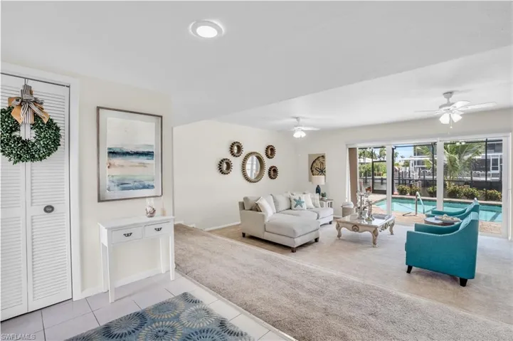 Tiled living room featuring ceiling fan
