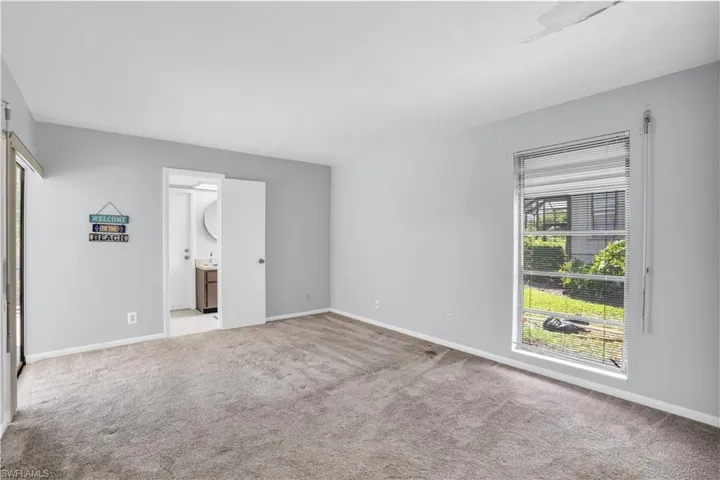 Empty room with light colored carpet