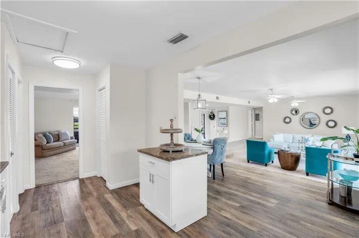 Kitchen with finishes, white cabinetry, sink, and backsplash