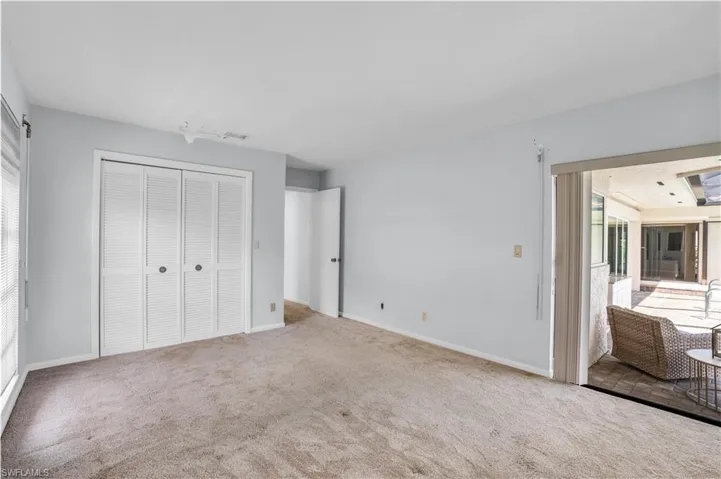Unfurnished bedroom featuring carpet flooring and a closet