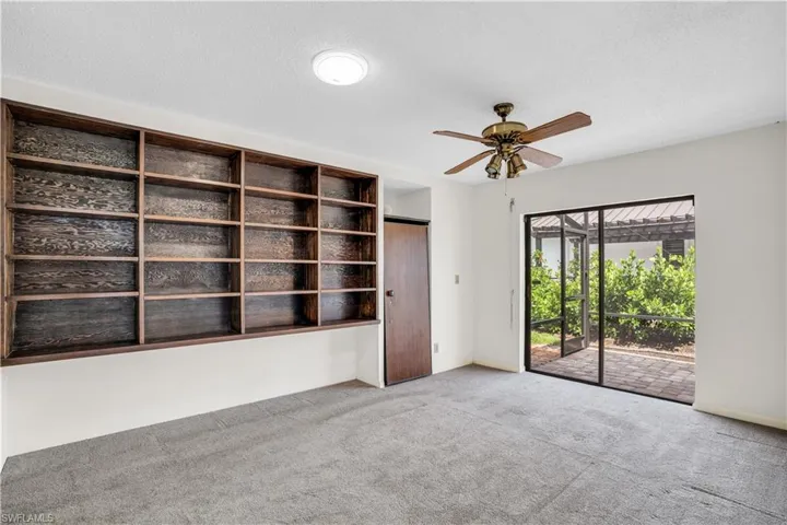 Carpeted spare room with a textured ceiling and ceiling fan