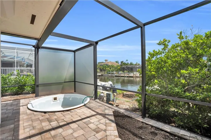 Unfurnished sunroom featuring a water view
