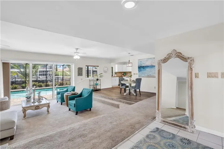 Living room with ceiling fan and wood-type flooring