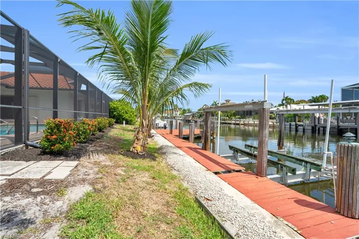 View of dock with glass enclosure and a water view