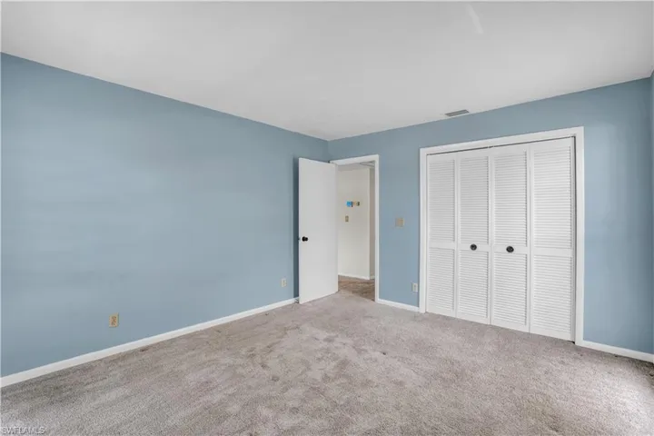 Unfurnished bedroom featuring a closet and carpet floors