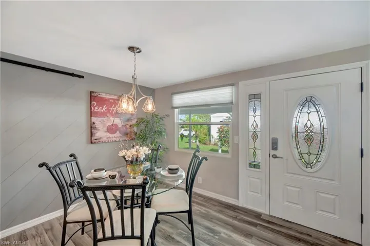 Dining room featuring hardwood / wood-style flooring and an inviting chandelier