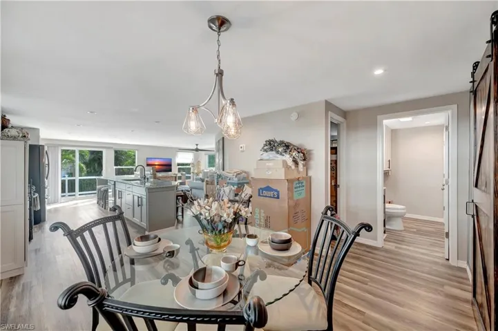 Dining area featuring light hardwood / wood-style flooring, a notable chandelier, and sink