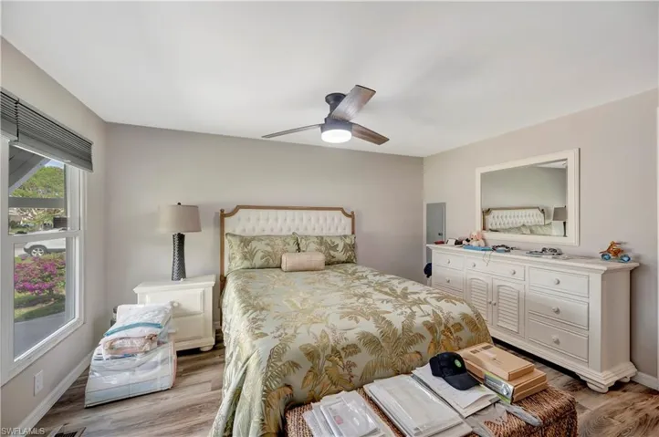 Bedroom with ceiling fan and light wood-type flooring