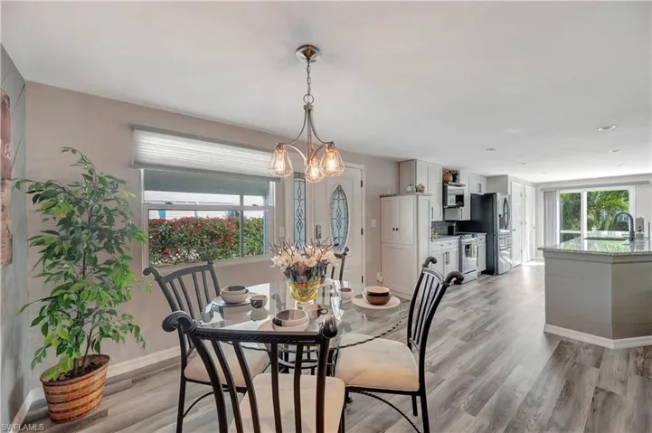Dining area featuring a chandelier, light wood-type flooring, and sink