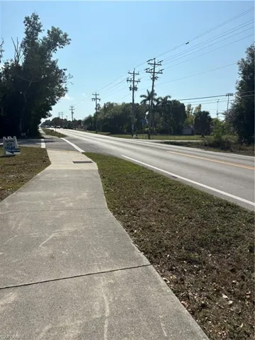 View of asphalt street featuring sidewalks