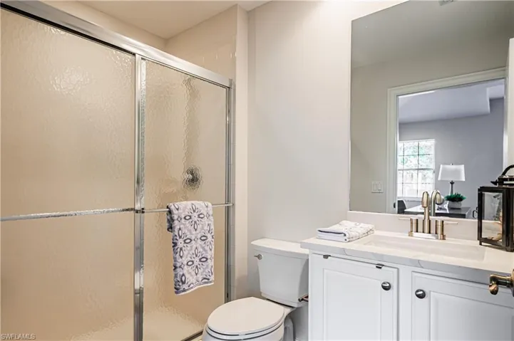 Full bath with vanity and a shower stall
