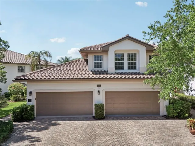 Mediterranean / spanish house featuring stucco siding, a garage, driveway, and a tile roof
